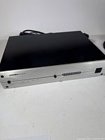 Front right angled view of Panamax M5100-EX power conditioner showing brand name, model, and control buttons.