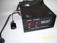Front view of the power supply showing power and charger switches, brand and model details.