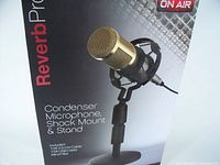 Photo of the Reverb Pro microphone kit packaging showing the gold condenser microphone in a shock mount and stand.