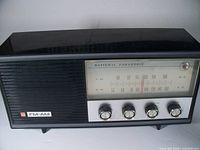 Front view of the vintage National Panasonic tube table radio showing the FM-AM dial, speaker grille, and four control knobs.