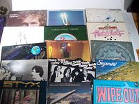 Photo of 14 vinyl LP records laid out in rows on a surface showing album covers for Gordon Lightfoot, Christopher Cross, Kenny Loggins, Cheap Trick, Styx, Segarini, and others.