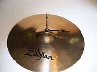 Front view showing Zildjian logo and clock hands mounted on cymbal surface.