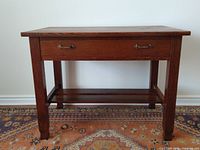 Full front view showing table with drawer and lower shelf