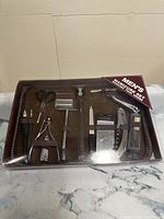 Opened full manicure set showing all tools neatly arranged and secured in brown zippered case.