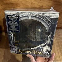Front view of sealed collector's DVD gift set box featuring the iconic Return of the King title and visible 3D model inside.