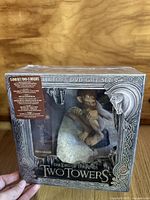 Front view of the unopened collector's edition DVD box set showing Gollum figurine inside and ornate box design.