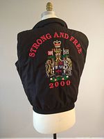 Back of the vest showing full multicolor embroidered Canadian coat of arms and text 'STRONG AND FREE 2000'