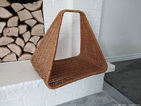 Front angle showing triangular wicker basket with integrated handle