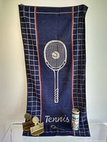 Full lot showing brass bookends, bottle opener, towel and vintage tin of balls