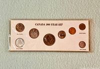 Front view of the original plastic-sealed mint card showing all six coins and composition labels