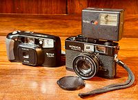 Konica Auto S3 and Fujifilm DL-90 cameras with Rollei flash mounted on Konica, lens cap removed