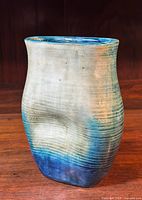 Front three-quarter view of vase showing ribbed exterior and gradient glaze
