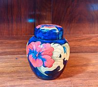 Frontal view of jar showing overall shape and Hibiscus pattern on body and lid