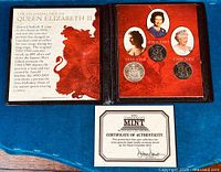 Photo showing the open coin set folder with four coins and printed historical information about Queen Elizabeth II's portraits.