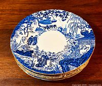 Stack of six vintage Royal Crown Derby Mikado pattern dinner plates showing blue and white Asian landscape and figures.