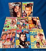 Overview photo showing 9 vintage teen heartthrob magazines arranged on blue fabric background