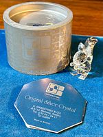 Photo showing the Swarovski squirrel figurine next to the original branded box and booklet.