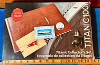 Full view of the original Titanic Collector Set box including leather album, coins, stamp sheet, and stock certificate.