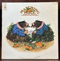 Front album cover showing artwork of two moles and title matching mole with band member names.