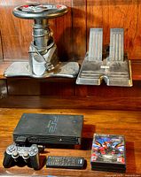 Full set including steering wheel with buttons and pedals, PlayStation 2 console, controller, remote, and game case.