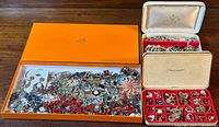 Wide view showing three boxes containing a large variety of vintage jewelry pieces including earrings, bracelets, rings, and brooches.