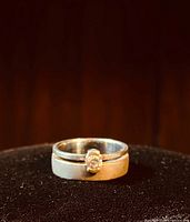 Close-up image of the sterling silver solitaire ring on a black velvet display, showing cutout band and CZ stone.