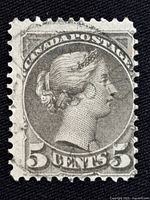 Close-up image of the 5 cent Canada postage stamp featuring Queen Victoria, showing details of the engraving and cancellation marks.