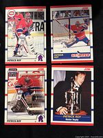 Four Patrick Roy hockey cards shown face up, featuring action shots and a trophy image.
