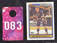 Photo of item alongside a numbered card for identification (083), showing front side of hockey card featuring Rod Brind'Amour in St Louis Blues uniform.
