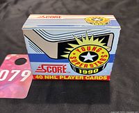 Photo showing unopened box of 1990 Score Hockey Young Superstars 40 NHL player cards, with colorful graphics and logos visible.