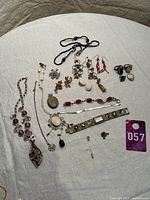Overview of assorted jewelry items on white cloth
