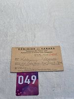 Close up photo of the Dominion of Canada Temporary War Ration Card showing serial number, name, and address.
