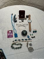 Overview of all jewelry items laid out on white cloth