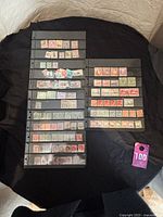 Full view of two black album pages with various stamps from India and Pakistan in different colors and denominations.