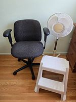 Office chair, tall floor fan, and step stool grouped together showing overall condition and appearance