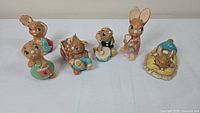 View of six Pendelin Bunnies figurines arranged in a row, showing their individual details and colors.