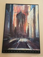 Full view of the print on board showing a vertical cityscape with a tall building in the center, dynamic brush strokes, warm tones and the artist's name at the bottom.