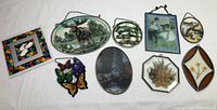 Lot of eight assorted stained glass and decorative wall hangings on a white background showing various wildlife and nature themes.