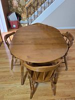 Top view of dining table with two chairs, showing table surface and shape.
