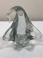 Full front view of clear glass dove figurine highlighting shape and internal bubbles.