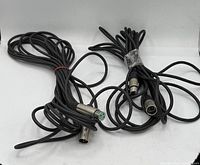 Two coiled black cables with XLR male and female connectors