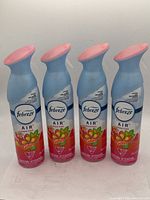 Four bottles of Febreze AIR air freshener Gain Island Fresh scent, 250 g each, side by side showing front labels and spray nozzles.