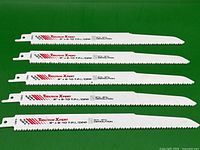 Five Tooltech Xpert 9-inch demolition sawzall blades laid out flat on green background showing full length with printed brand and specifications.