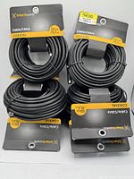Six coiled black Black Web coaxial cables with packaging cards, showing length and price