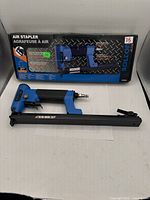 Photo showing Bolton Pro air stapler placed in front of its original packaging box displaying product and branding details.