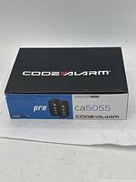 Box of Code Alarm Remote Start and Keyless Entry System model CA5055 showing branding and remote key fob images
