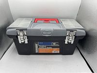 Closed view of the Stinson 16 inch toolbox showing double metal latches and two pull out organizers on the lid sides.