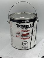 Front view of 3.7L Tremclad paint can showing label and metal handle, with paint drips on the exterior and minor tin damage.