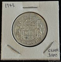 Reverse side of the 1943 Canadian silver 50 cent coin showing the Canadian Coat of Arms with denomination and year.