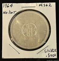 Front side (reverse) of 1964 Canadian Silver 1 Dollar coin showing floral emblem and inscriptions.